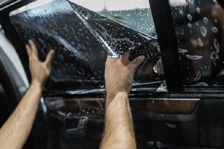 Car tinting in Sharjah by BlackFeather using heat gun for professional window tinting Dubai and Sharjah